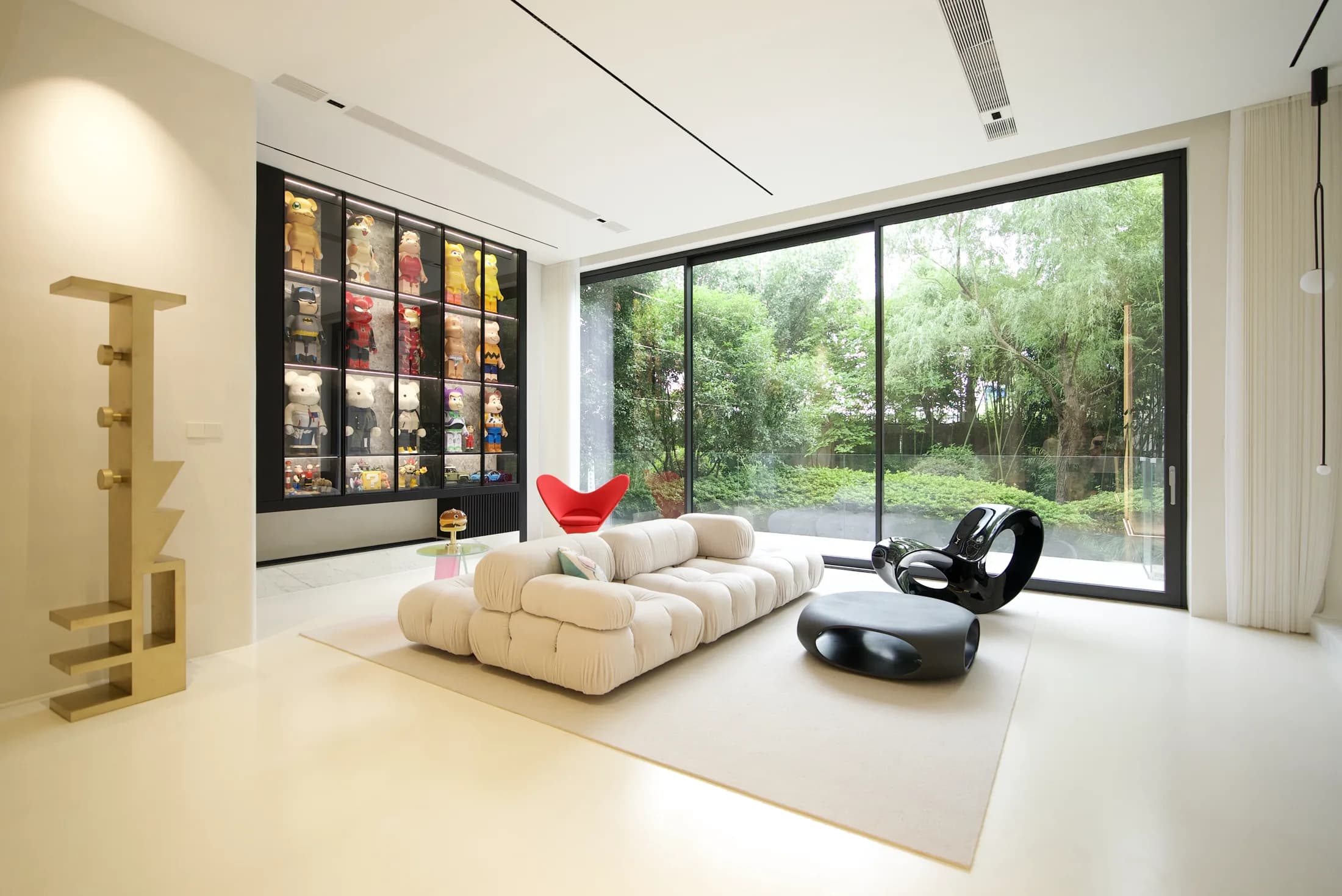 Large glazed openings and sliding displays for contemporary residential spaces.